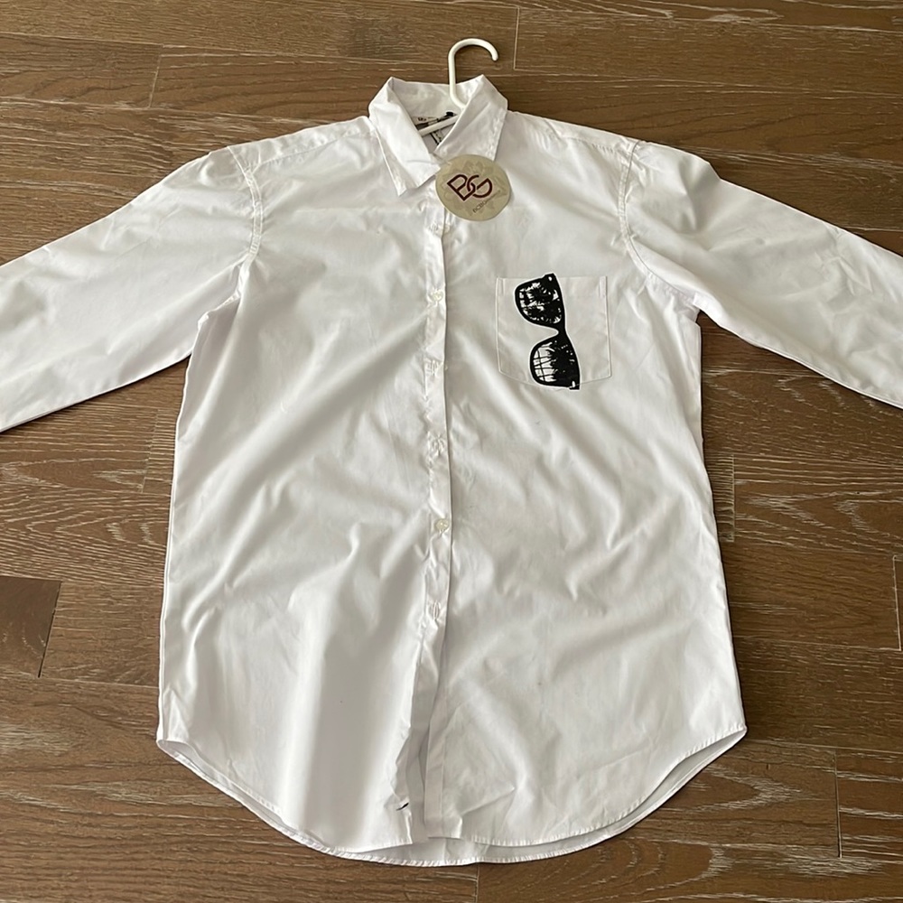 White shirt.Oversized. Sunglass image on front pocket, Love Generation on back.